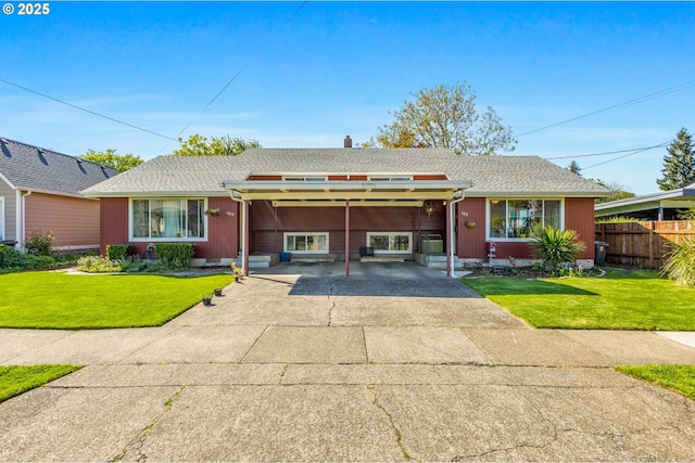 520 NW 10th St, Corvallis, OR 97330 - split level home with fence, an attached carport, concrete driveway, and a front yard
