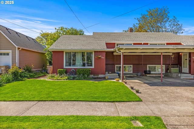 520 NW 10th St, Corvallis, OR 97330 - split level home with driveway, a chimney, roof with shingles, a front yard, and a carport