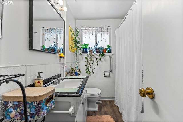 520 NW 10th St, Corvallis, OR 97330 - bathroom featuring vanity, wood finished floors, toilet, and tile walls