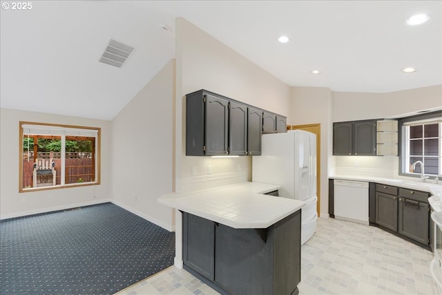 257 SW Nancy Cir, Gresham, OR 97030 - kitchen with white appliances, a peninsula, light countertops, lofted ceiling, and recessed lighting