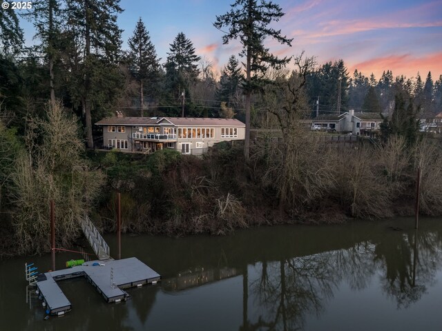 view of front of home with a water view and a garage