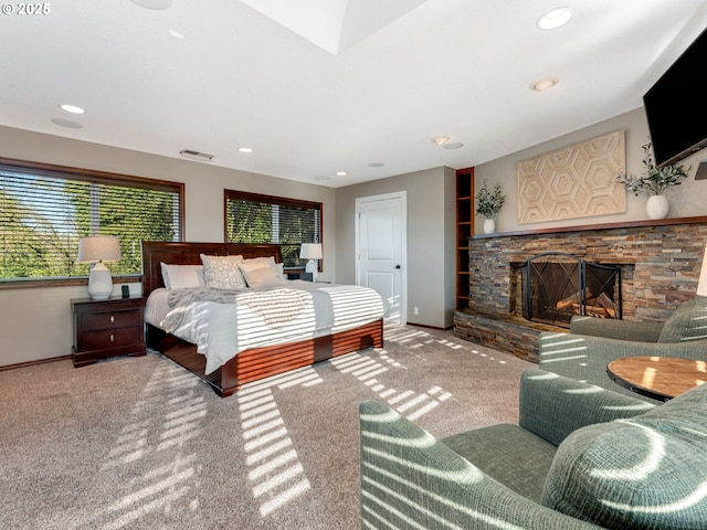 bedroom with carpet floors and a fireplace