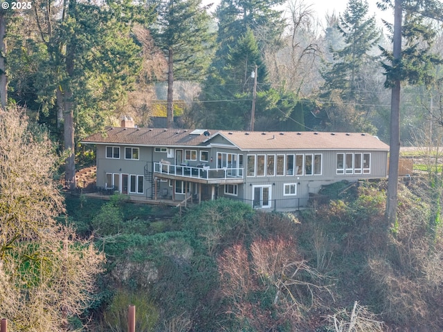 rear view of house with a wooden deck