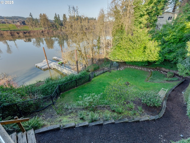 view of yard featuring a water view and a boat dock