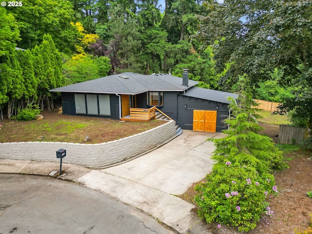 16880 Cortez Ct, Lake Oswego, OR 97035 - view of front of house with a chimney, driveway, and a shingled roof
