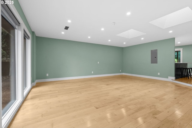 16880 Cortez Ct, Lake Oswego, OR 97035 - spare room featuring a skylight, electric panel, light wood-style flooring, baseboards, and recessed lighting