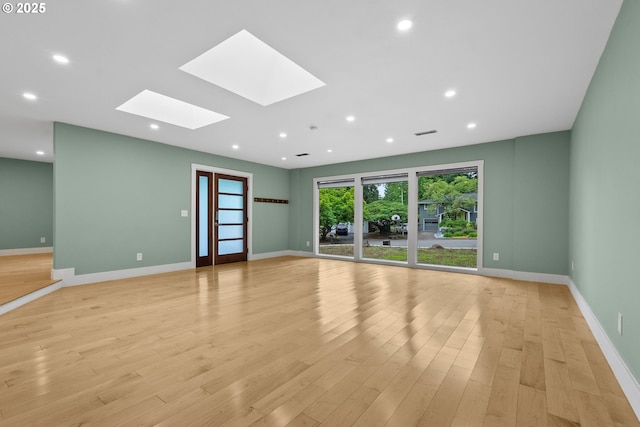 16880 Cortez Ct, Lake Oswego, OR 97035 - empty room featuring a skylight, baseboards, light wood-type flooring, and recessed lighting