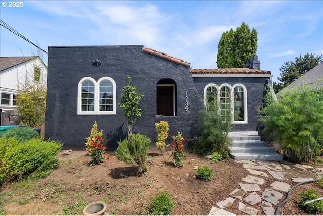 1235 N Farragut St, Portland, OR 97217 - mediterranean / spanish house featuring stucco siding and a tiled roof