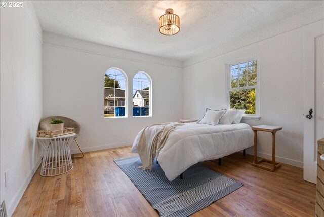 1235 N Farragut St, Portland, OR 97217 - bedroom featuring multiple windows and wood finished floors