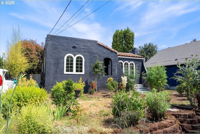1235 N Farragut St, Portland, OR 97217 - mediterranean / spanish-style house featuring stucco siding and a tiled roof