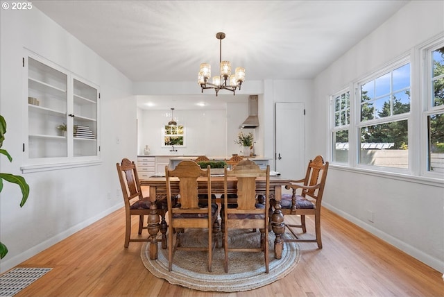 1235 N Farragut St, Portland, OR 97217 - dining room featuring light wood-style flooring and a chandelier