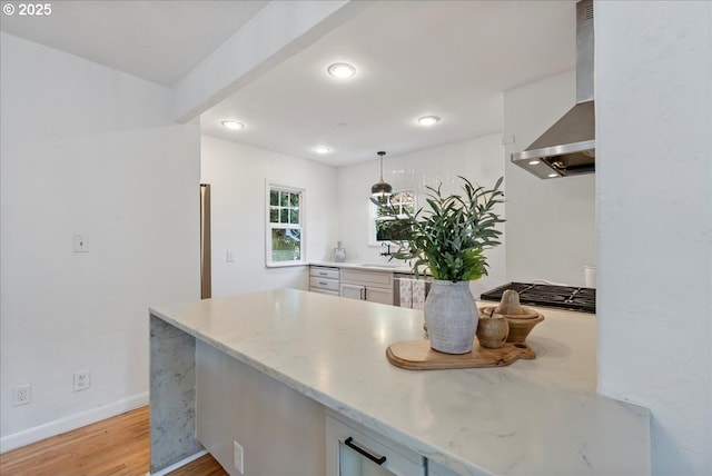1235 N Farragut St, Portland, OR 97217 - kitchen featuring wall chimney range hood, white cabinetry, light wood-type flooring, stainless steel gas stovetop, and light stone countertops