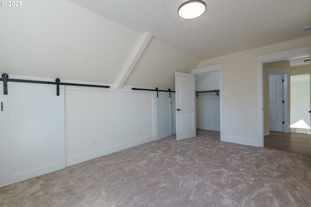 535 E St, Independence, OR 97351 - additional living space featuring carpet floors, baseboards, vaulted ceiling, and a barn door