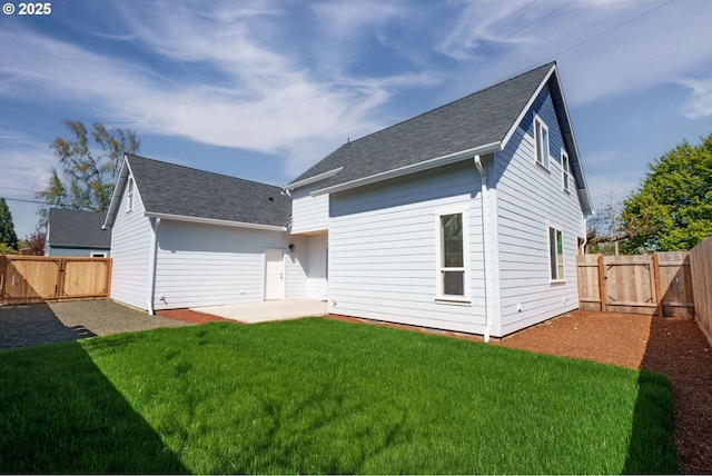 535 E St, Independence, OR 97351 - rear view of property with a patio, a fenced backyard, a gate, and a lawn