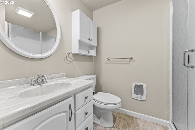 bathroom featuring tile patterned flooring, vanity, a shower with door, and toilet