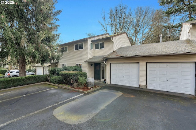 view of front of property with a garage and aphalt driveway