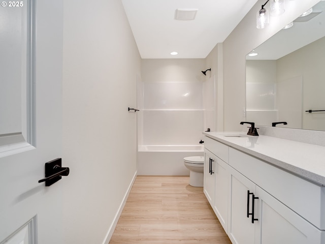 full bathroom with vanity, toilet, hardwood / wood-style floors, and shower / bathing tub combination