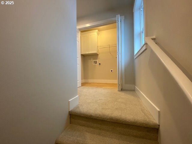 staircase featuring carpet flooring and baseboards