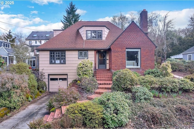 view of front of house with a garage, concrete driveway, and a chimney