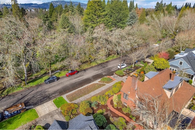 birds eye view of property featuring a wooded view