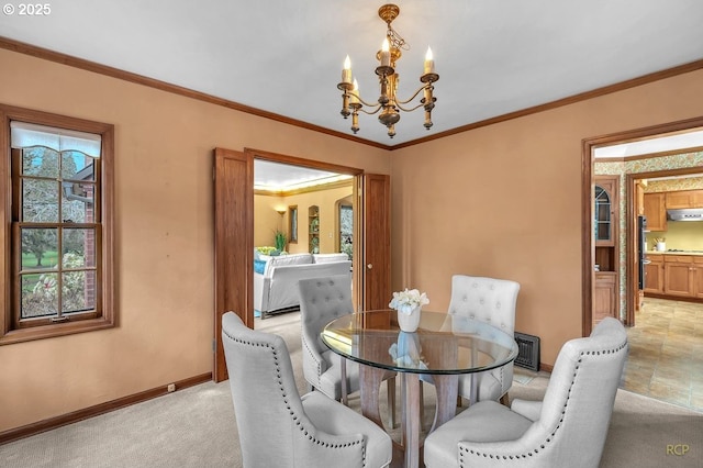 dining room with ornamental molding, light colored carpet, baseboards, and a chandelier