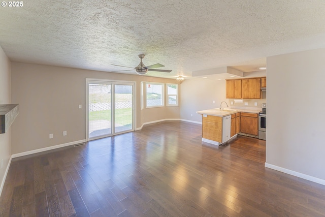kitchen featuring stainless steel electric range oven, white dishwasher, ceiling fan, a peninsula, and open floor plan