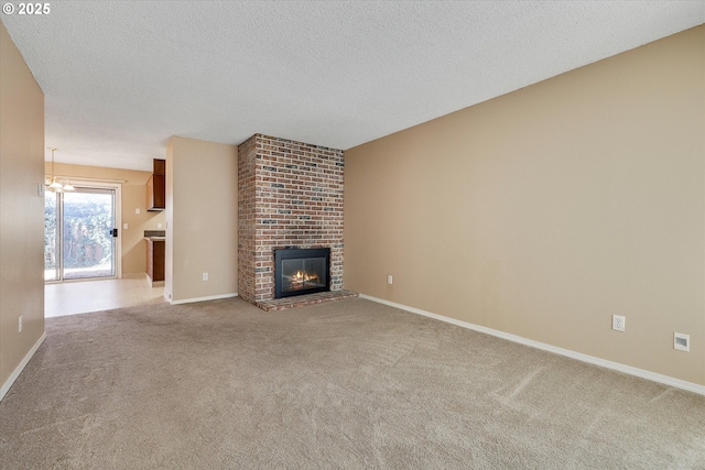 unfurnished living room featuring light carpet, a textured ceiling, and a fireplace