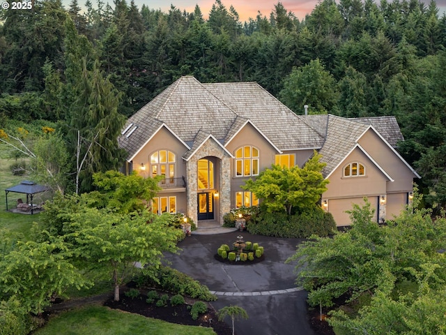 23720 SW Stafford Hill Dr, West Linn, OR 97068 - traditional-style home with stucco siding, stone siding, a balcony, french doors, and driveway