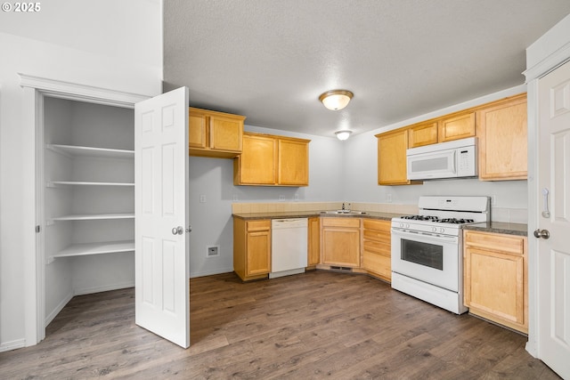 888 SE Kierra Pl, Madras, OR 97741 - kitchen featuring white appliances, dark wood-style flooring, dark countertops, and a sink