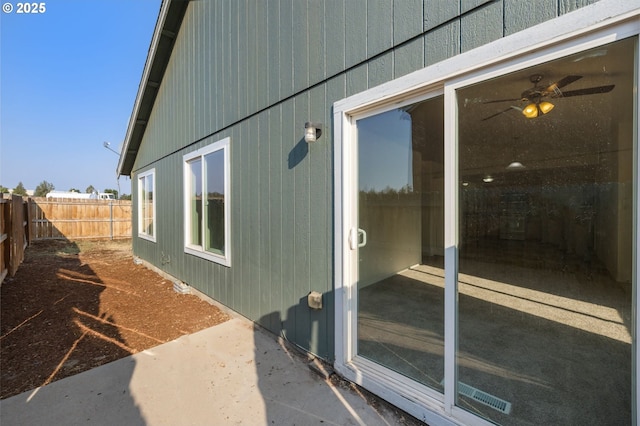 view of home's exterior featuring a fenced backyard and ceiling fan