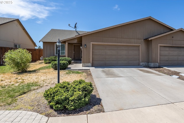 888 SE Kierra Pl, Madras, OR 97741 - view of front of property with a garage, concrete driveway, roof with shingles, and fence
