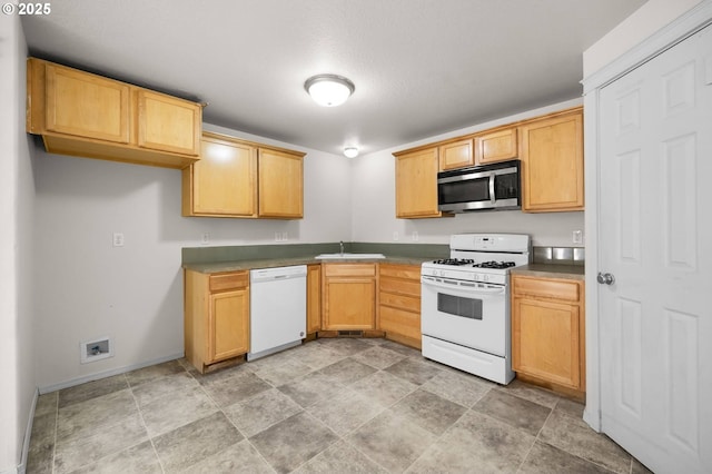 888 SE Kierra Pl, Madras, OR 97741 - kitchen with light brown cabinets, white appliances, a sink, and baseboards