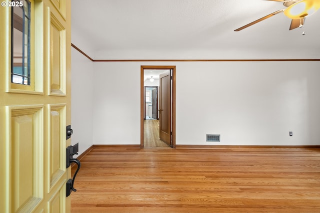 unfurnished room featuring ceiling fan and light wood-type flooring