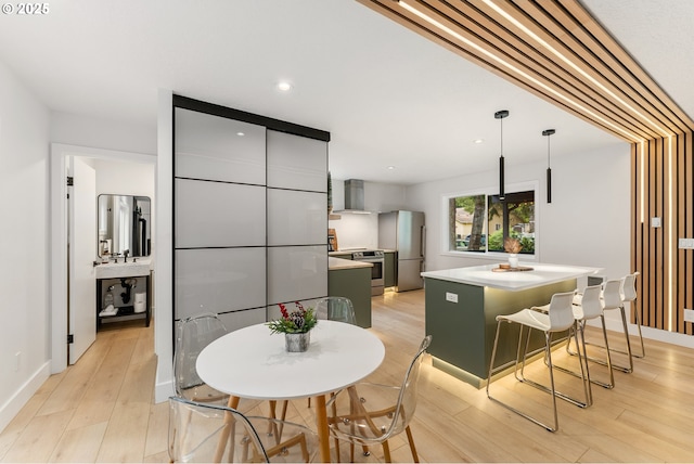 dining area with recessed lighting, light wood finished floors, and baseboards