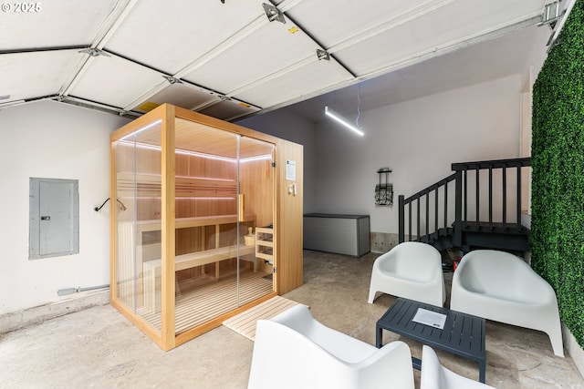 bedroom with concrete flooring and electric panel