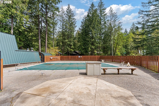 view of swimming pool with a fenced in pool, fence, and a patio