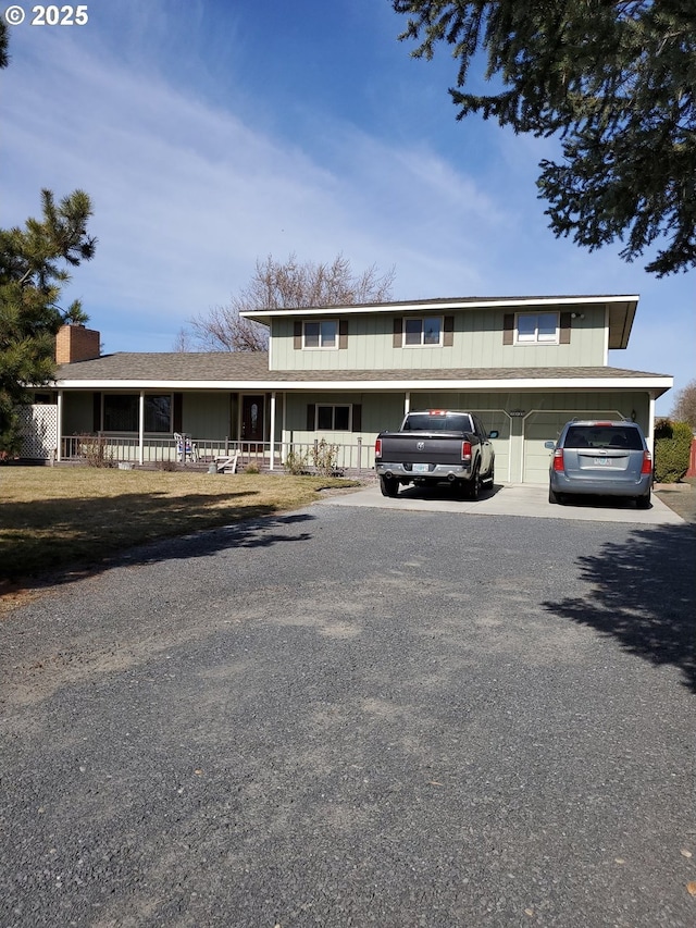 view of front of house with driveway and a porch