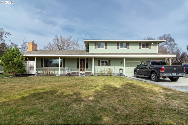 traditional-style home with a front yard, concrete driveway, covered porch, and an attached garage