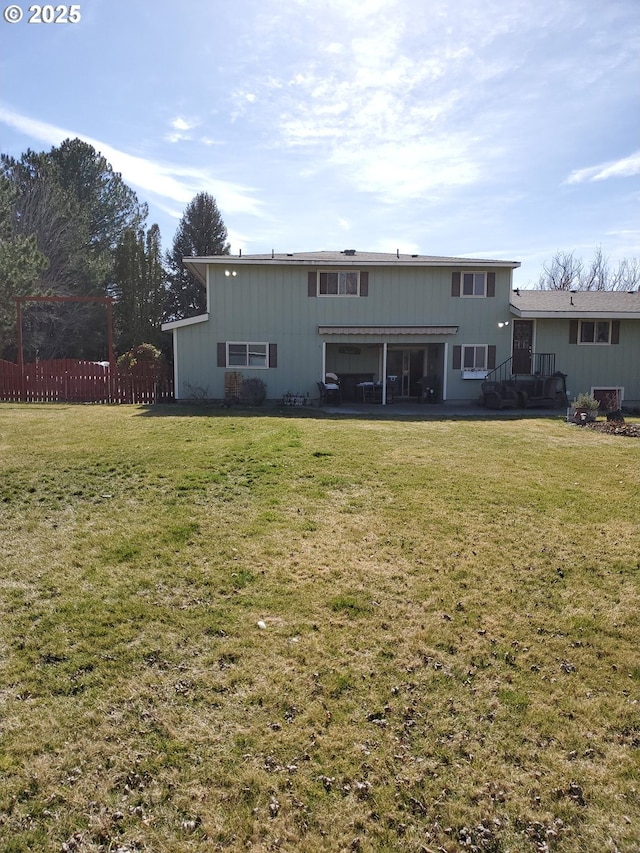 back of house featuring a lawn