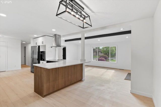 kitchen featuring island range hood, stainless steel fridge with ice dispenser, light countertops, white cabinetry, and open floor plan