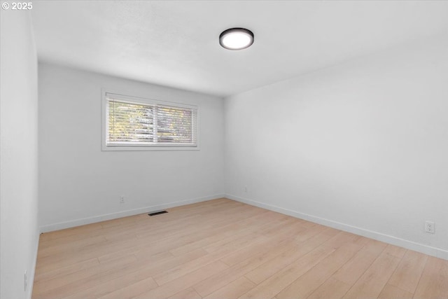unfurnished room featuring light wood-style flooring and baseboards