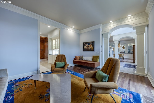 1564 Regency Dr, Eugene, OR 97401 - living area featuring decorative columns, ornamental molding, arched walkways, baseboards, and wood finished floors