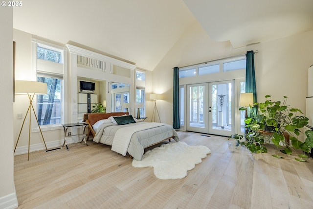1564 Regency Dr, Eugene, OR 97401 - bedroom featuring french doors, access to outside, high vaulted ceiling, multiple windows, and baseboards