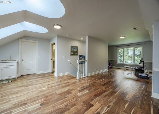 1564 Regency Dr, Eugene, OR 97401 - living room featuring light wood-style flooring, a skylight, and baseboards
