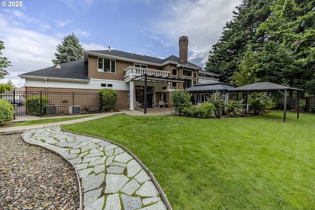 1564 Regency Dr, Eugene, OR 97401 - rear view of house with a gazebo, a chimney, a patio, cooling unit, and roof with shingles
