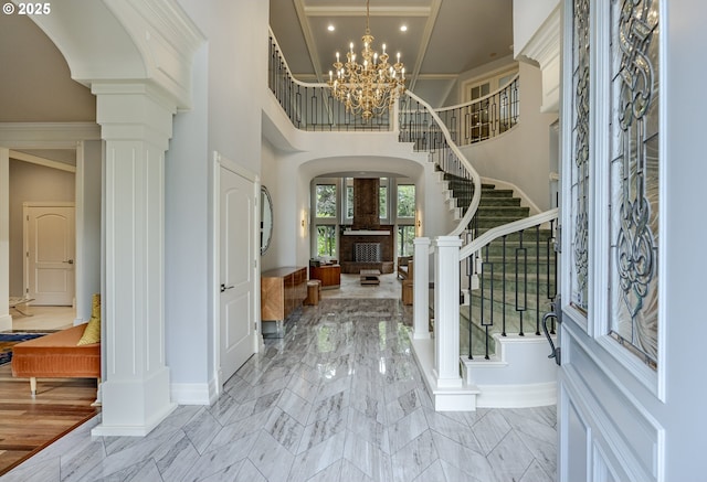 1564 Regency Dr, Eugene, OR 97401 - entrance foyer featuring arched walkways, stairway, ornate columns, baseboards, and ornamental molding