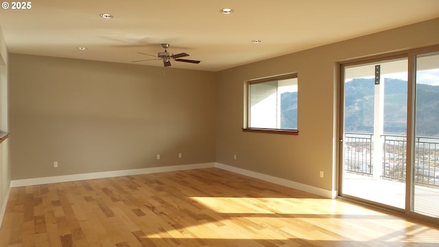 unfurnished room with light wood-style flooring, ceiling fan, baseboards, and recessed lighting