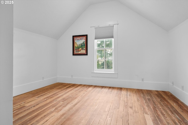 additional living space featuring lofted ceiling and wood-type flooring