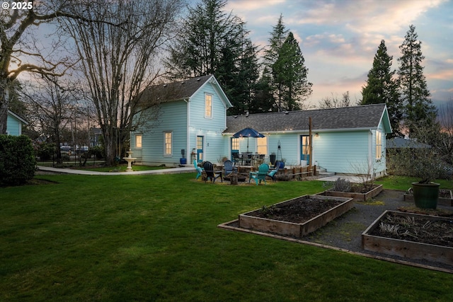 rear view of property with a garden and a yard