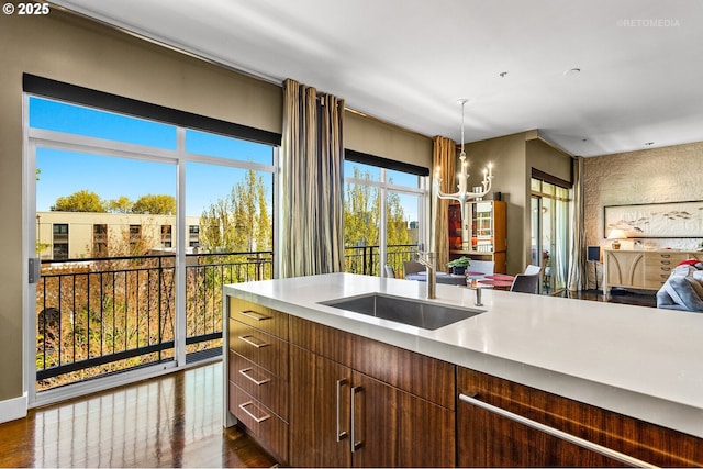 kitchen with sink, an inviting chandelier, dark hardwood / wood-style flooring, and decorative light fixtures